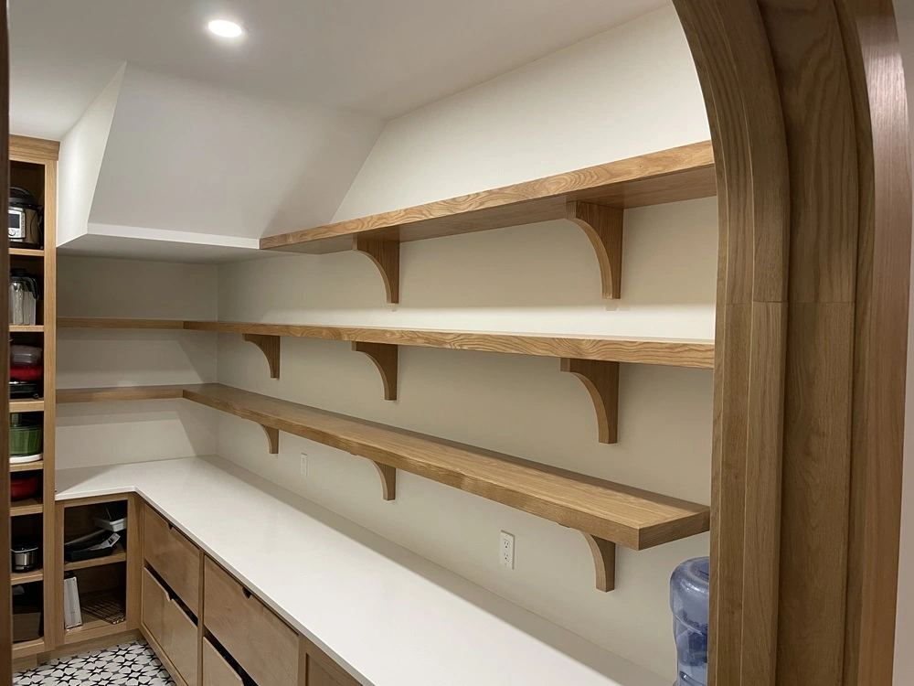 Kitchen pantry shelving in white oak with custom wall brackets featuring an elliptical curve.